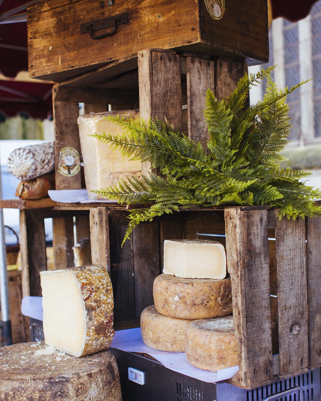 A stack of wheels of French cheese. French cheese is just one delicious food to be found in Paris.