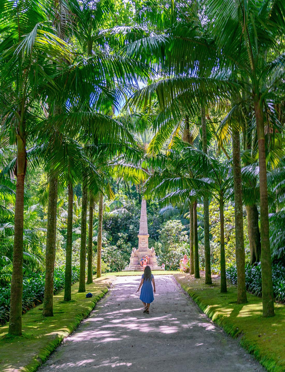 Sao Miguel Azores - woman walking down a path lined with palm trees