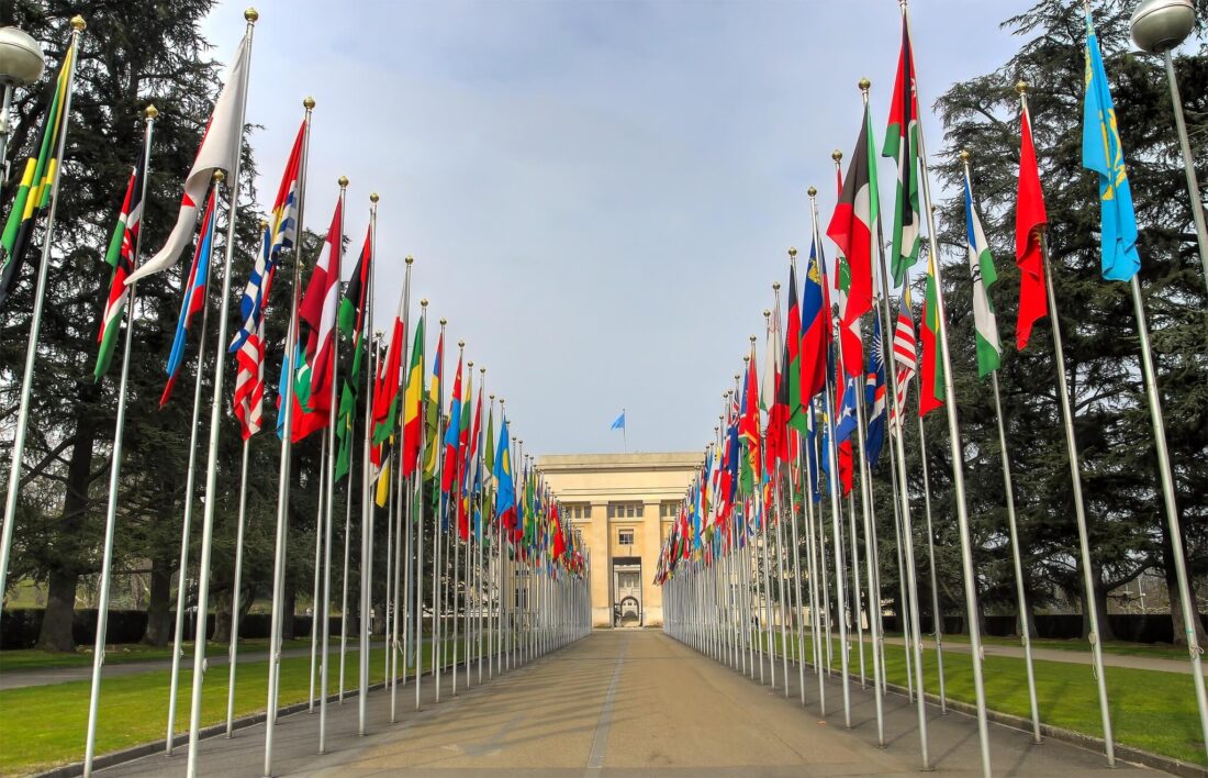 Two rows of international flags leading to a building in Geneva Switzerland 