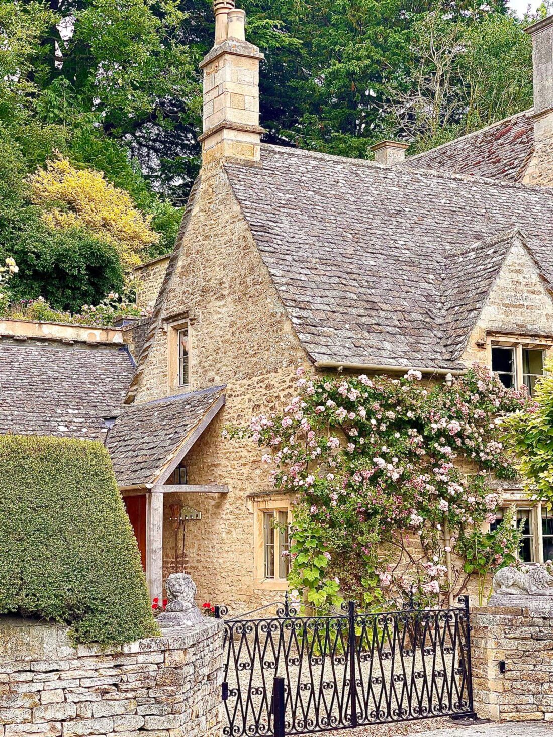 Most Beautiful Cotswolds Villages - Limestone Cottage covered in pink roses