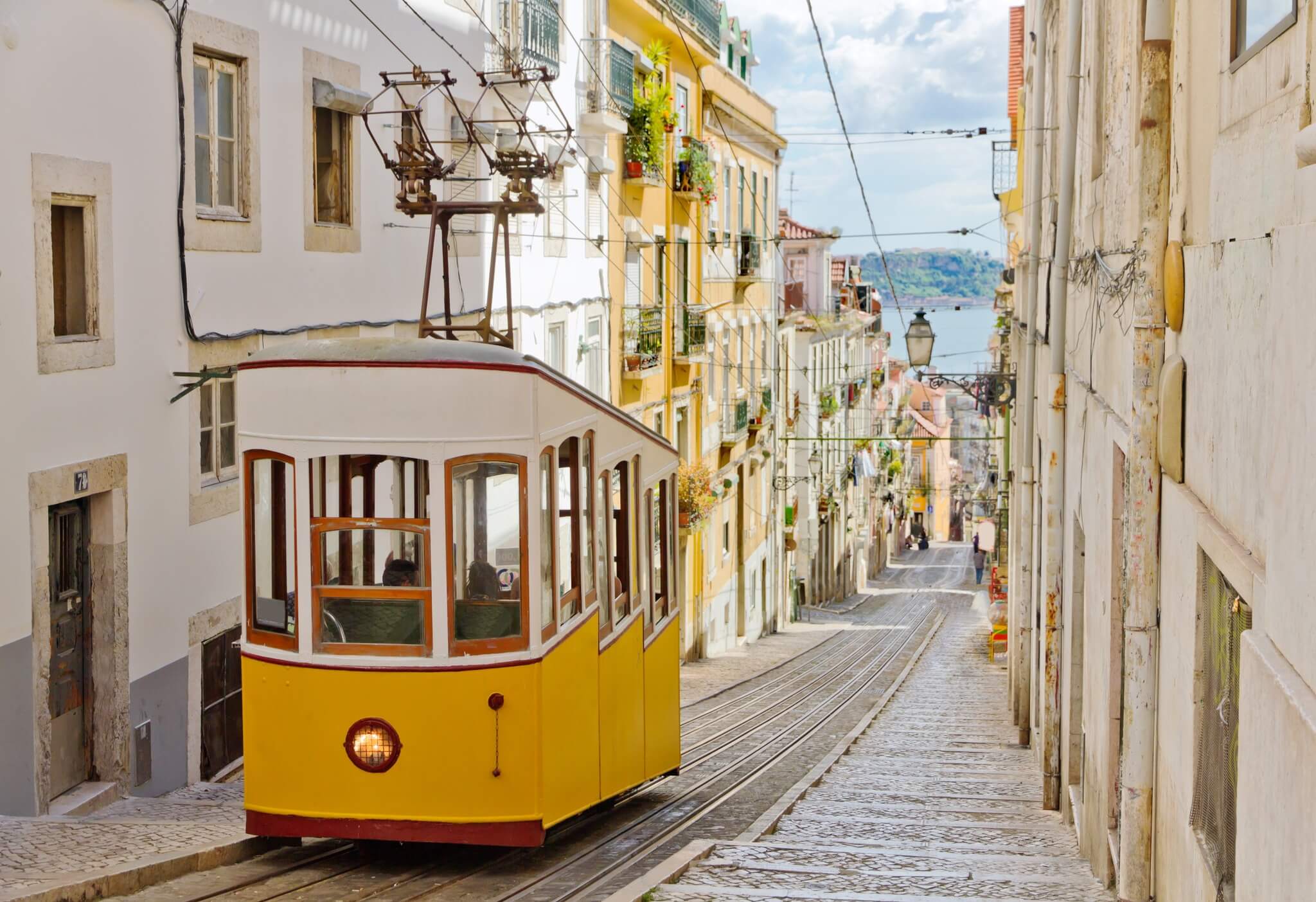 Yellow Trolley in Lisbon going down hill on a track